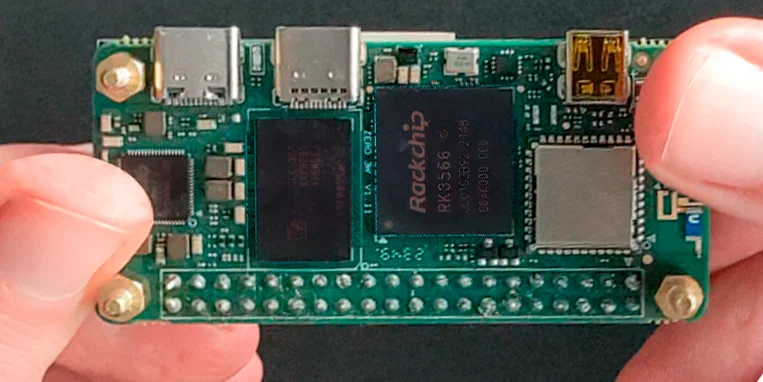 The Radxa Zero 3W single-board computer held in hands, showcasing the Rockchip RK3566 SoC and LPDDR4X RAM chips that power the KVM 2.0.